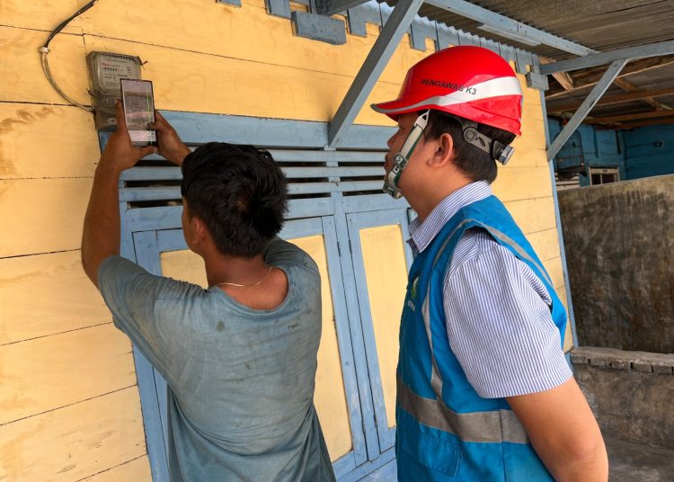 Petugas PLN ULP Tarutung,Ramoti Siagian sedang membantu pelanggan PLN dalam menggunakan fitur swacam di Aplikasi Mobil.(Satunusantara news/HO-Humas PLN UID Sumut).