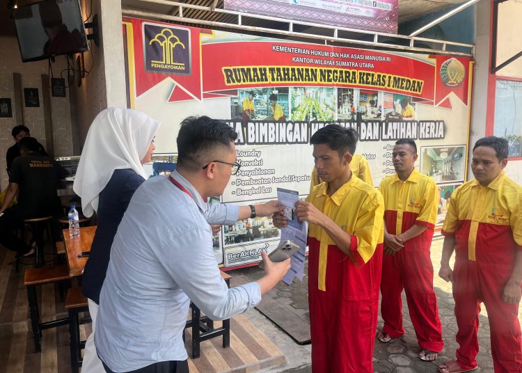 Pegawai Bank BRI, saat menyerahkan buku tabungan kepada WBP di Rutan Kelas I Medan.(Satunusantara.news/HO-Humas Rutan Medan).