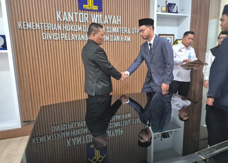 Kadiv  Pelayanan Hukum, Kanwil Kemenkum Sumut,Sahata Marlen Situngkir (kiri)  saat menyalami  Muhammad Razif,SH, usai dilantik sebagai  Notaris Pengganti,di Ruang Rapat Divisi Pelayanan Hukum Kanwil Kemenkum Sumut.(Satunusantara newsHO-Humas Kemenkum Sumut).