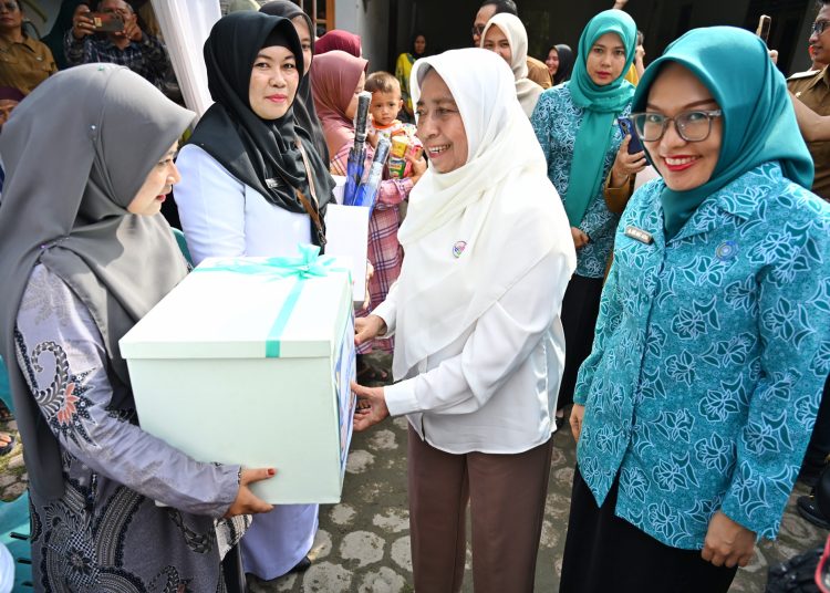 Wakil Ketua TP Posyandu Sumut, Titiek Sugiharti Surya  (tengah) didampingi Wakil Ketua TP Pos yandu Kota Tanjungbalai, Desi Khairina Trimurni (kanan) menyerahkan bingkisan , saat mengunjungi Pos Yandu Kemuning dan Posyandu Kamboja di Kota Tanjungbalai.(Satunusantara news/HO-Diskominfo Sumut).