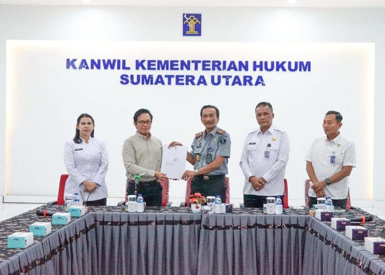 Kakanwil KemenHAM Sumut-Kepri, Flora Nainggolan (kiri) saat foto bersama dengan  Ketua Tim Pemeriksa BPK RI, Cahyo Nurhadi.(Satunusantara news/HO-Kanwil KemenHAM Sumut).