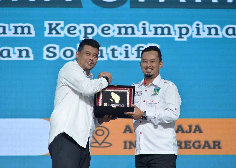 Gubernur Sumatera Utara  Muhammad Bobby Afif Nasution (kiri) saat menyerahkan cendramata kepada Ketua Umum PW KAMMI Sumut, Wira Putra, pada  Muswil VII PW KAMMI Sumut.(Satunusantara news/HO-Diskominfo Sumut),