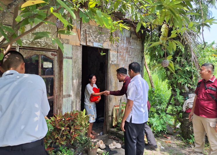 Kepala Rutan Kelas I Labuhan Deli, Eddy Junaedi  (kemeja putih) saat menyaksikan penyerahan sembako kepada warga.(Satunusantara news/HO-Rutan Labuhan Deli) .