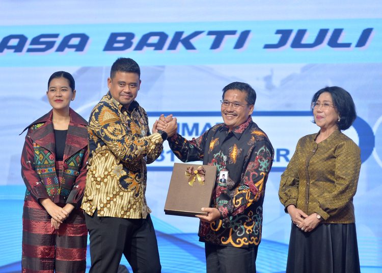 Gubernur Sumut   Muhammad Bobby Afif Nasution (kiri) saat menyerahkan cendramata kepada Togap Simangunsong yang sudah purna tugas sebagai Sekdaprov Sumut.(Satunusantara news/HO-Diskominfo Sumut)