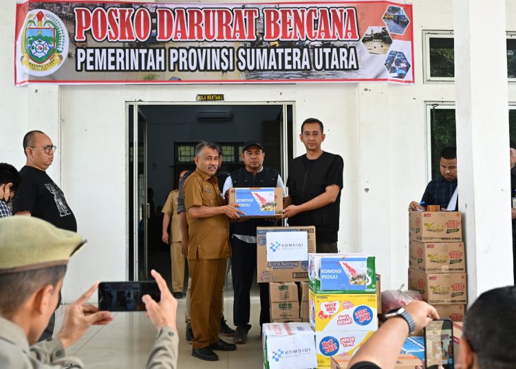 Ketua Harian Posko Darurat Bencana Sumut, Basarin Yunus Tanjung (kiri) saat menerima bantuan  dari Komdigi di Posko Darurat Bencana Sumut, di Medan.(Satunusantara news/HO-Diskominfo Sumut).