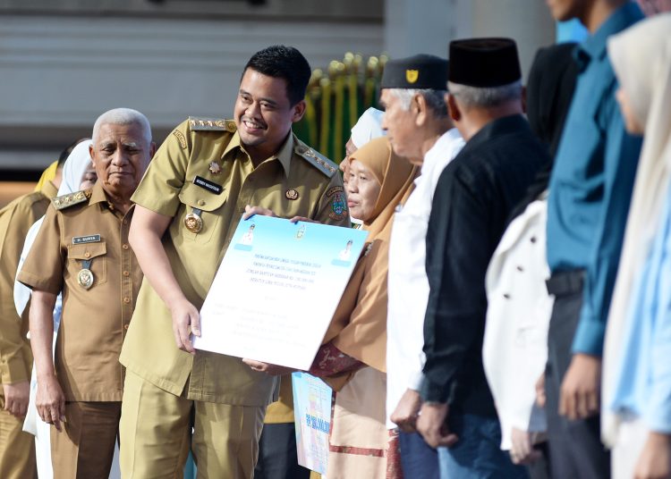 Gubernur Sumut, Muhammad Bobby Afif Nasution (kiri) saat menyerahkan bantuan hibah kepada masyarakat di Aula Raja Inal Siregar, Kantor Gubernur Sumut.(Satunusantara news/HO-Diskominfo Sumut).